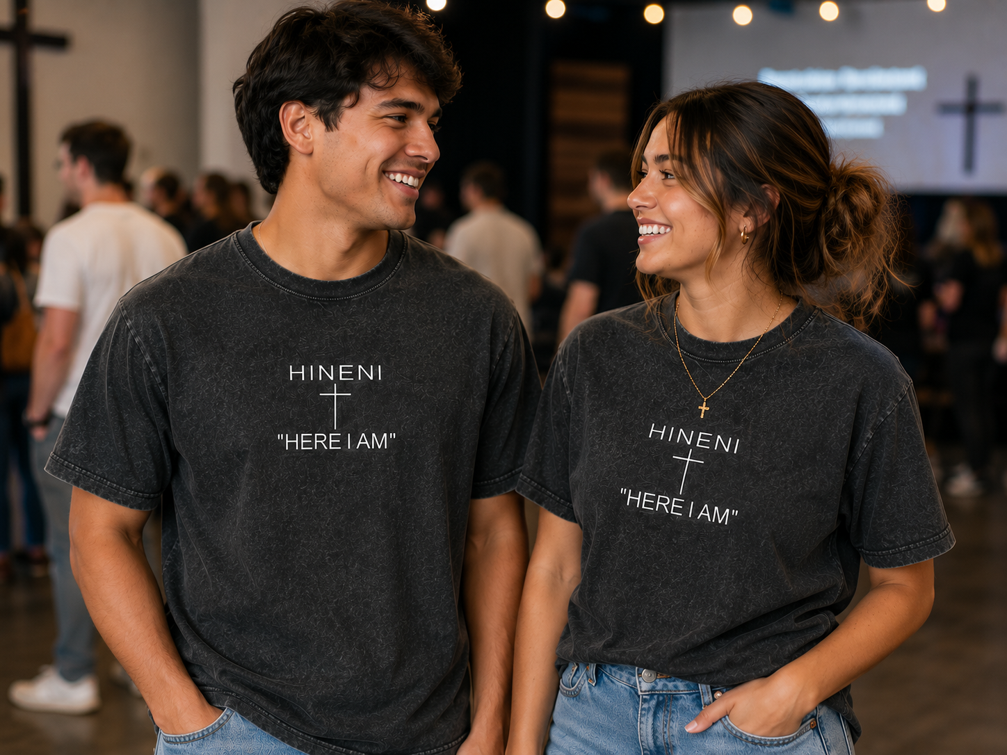 Two friends wearing the Here I Am shirt at a gathering